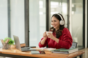 Asia businesswoman working on digital tablet executives meeting in an office using laptop...