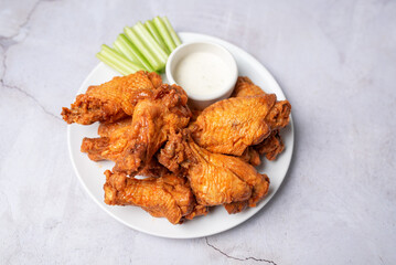 Buffalo chicken wings with celery and dip