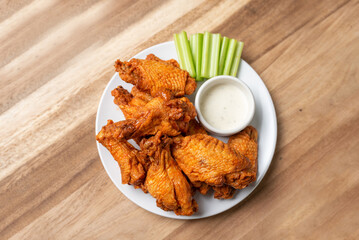 Buffalo chicken wings with celery and dip