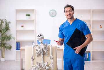 Young male doctor radiologist and skeleton patient at the hospit