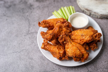 Buffalo chicken wings with celery and dip