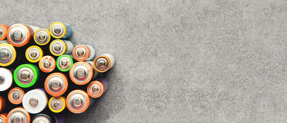 Alkaline batteries on grunge background with space for text