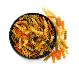 Plate of raw fusilli pasta on white background