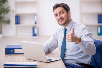 Young male employee working in the office