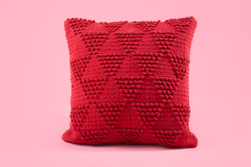 Red decorative pillow on pink background