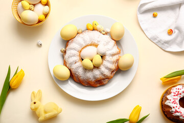 Composition with tasty Easter cake, painted eggs and tulip flowers on color background