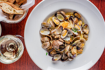 Seafood Pasta with clams. Pasta with clams, seafood, Parmesan cheese, spinach, and Italian parsley. Classic American or Italian restaurant favorite. Homemade pasta, tomato sauce, meats and cheeses.