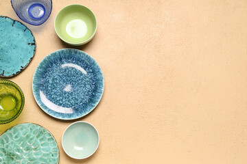 Composition with clean ceramic plates and bowls on beige background
