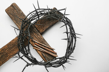 Fototapeta na wymiar Crown of thorns, nails and wooden cross on white background