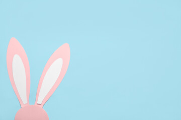 Paper bunny ears on color background