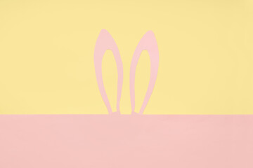 Paper bunny ears on color background