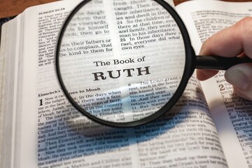 title page book of ruth close up using magnifying glass in the bible or Torah for faith, christian,...