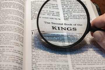 title page book of second kings close up using magnifying glass in the bible or Torah for faith,...