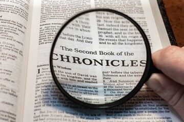 title page book of second chronicles close up using magnifying glass in the bible or Torah for faith, christian, hebrew, israelite, history, religion, christianity, Old Testament
