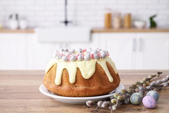 Easter cake with painted eggs and pussy willow branches on kitchen counter