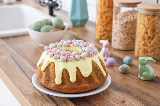 Easter cake with painted eggs and bunnies on kitchen counter