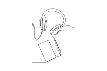 continuous line drawing of modern headphones with hardcover book on table