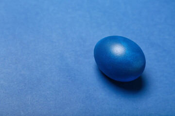 Painted Easter egg on blue background