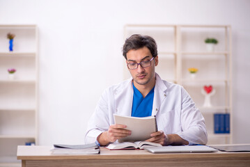 Young male doctor working in the clinic