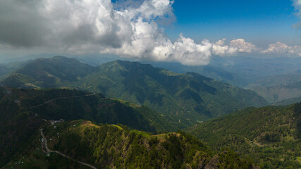 Aerial view of Fresh green foliage, tropical plants and trees covers mountains and ravine. Philippines.