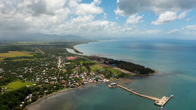 A town on the seashore with a port and a pier. Luzon, Santa Ana, Cagayan. Philippines.