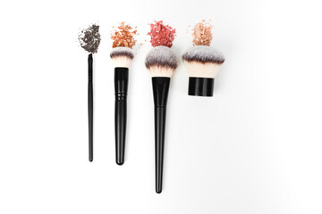 Makeup brushes and loose makeup products. 
Powder, blush, bronzer. Nude shades of decorative cosmetics.