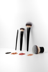Makeup brushes and loose makeup products. 
Powder, blush, bronzer. Nude shades of decorative cosmetics.