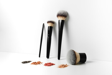 Makeup brushes and loose makeup products. 
Powder, blush, bronzer. Nude shades of decorative...