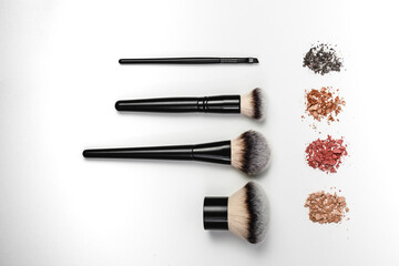 Makeup brushes and loose makeup products. 
Powder, blush, bronzer. Nude shades of decorative...