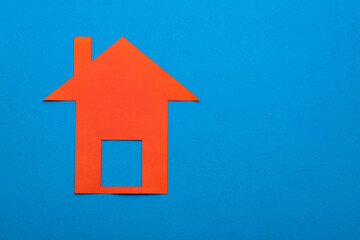 Fototapeta na wymiar Home buying and selling concept - Red paper house on blue color background