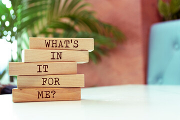 Wooden blocks with words 'WHAT'S IN IT FOR ME ?'.