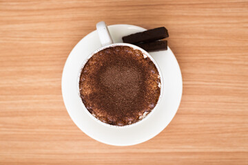 A Cup of hot chocolate, sprinkled with chocolate powder on top