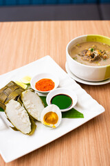 A Traditional Makassar dish, called Coto Makassar served with packed rice and a side of salted egg