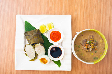 A Traditional Makassar dish, called Coto Makassar served with packed rice and a side of salted egg