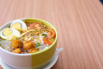 A Plate of Soto Ayam served with rice and condiments