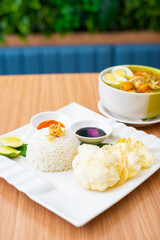 A Plate of Soto Ayam served with rice and condiments