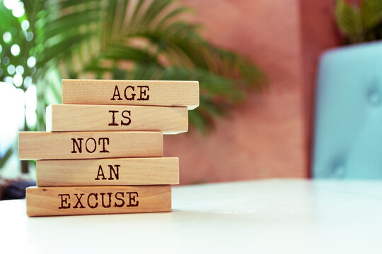 Wooden blocks with words 'Age is not an excuse'.