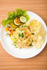 A Plate of vegetable salad served with indonesian crisps