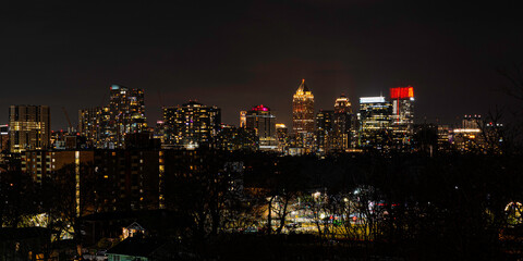 Fototapeta premium Atlanta City Skyline at Night with Skyscrapers and Buildings at Cloudy Twilight over the Trees in Georgia
