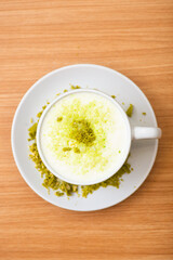 A Glass of matcha drink, served with crumble of matcha chocolate