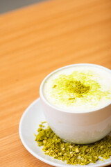 A Glass of matcha drink, served with crumble of matcha chocolate
