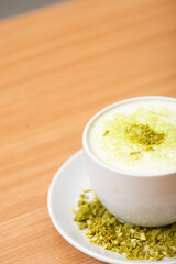 A Glass of matcha drink, served with crumble of matcha chocolate
