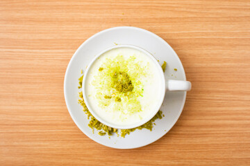 A Glass of matcha drink, served with crumble of matcha chocolate