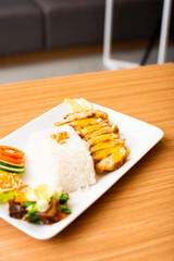 A Lemon Chicken Cutlet Dish, Servied with Rice and a side of salad