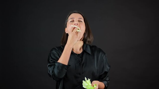 Young Female Vegan Eating Cabbage Leaf Passionately in Front of Camera, Slow Motion