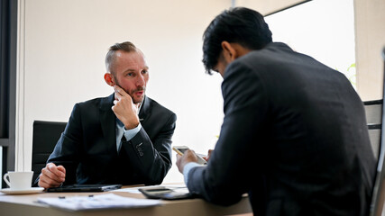 Professional Caucasian businessman is talking with his employee in the meeting.
