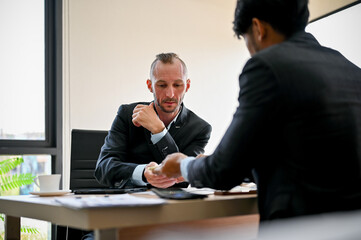Successful Caucasian businessman is in the meeting with his business partner
