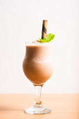 Chocolate milkshake served with a chocolate wafer straw