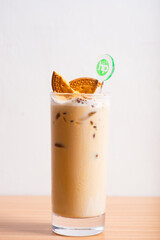 A glass of coffee served with cookies