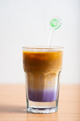 A Cup of latte served with syrup